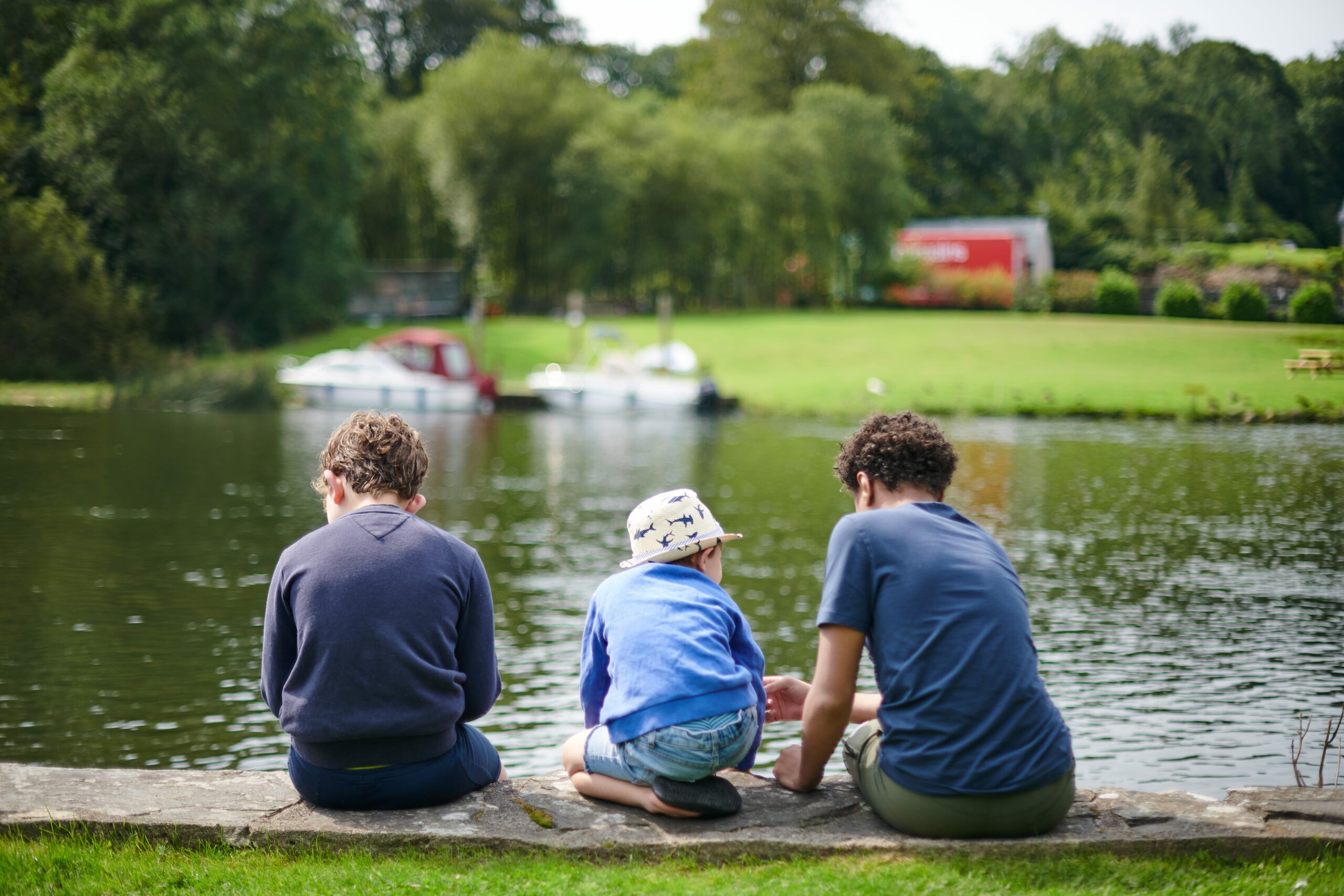 children-sat-on-river-bank